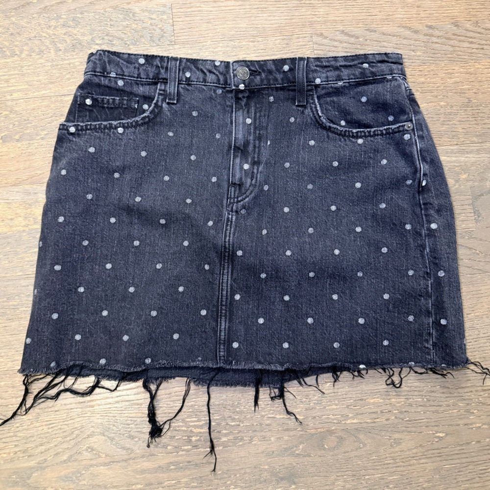 Current/Elliott The 5 Pocket Mini Skirt in black polka dot denim with a raw hem.